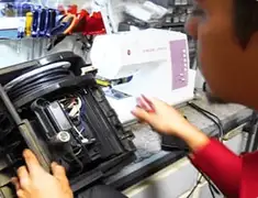 Vacuum repair technician servicing internal components on a workbench in Memphis, TN