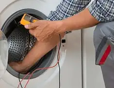 Washing machine repair technician testing a front-load washer with diagnostic tools in Memphis, TN